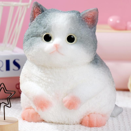 Actual gray and white Mochi Taba Cat SKU with glossy eyes, tiny paws, and a chunky flocked body.