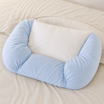 Aftercare pillow shaped around a standard pillow to show its wraparound form.